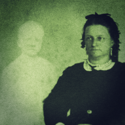 A green-tinted spirit photograph of a woman dressed in black beside a ghostly child.
